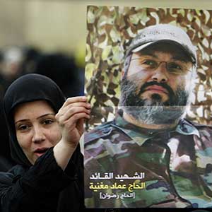 Woman in Beirut holds poster of Imad Mughniyah